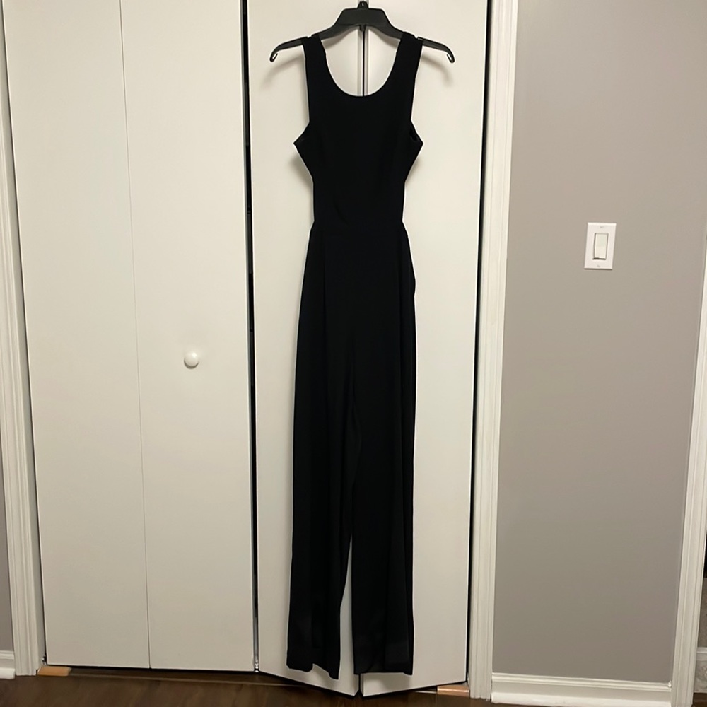 Black BCBG jumpsuit, has wide leg and open back